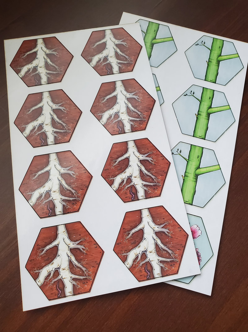 Fruit cardboard punch-out sheets showing root and stalk hex tiles